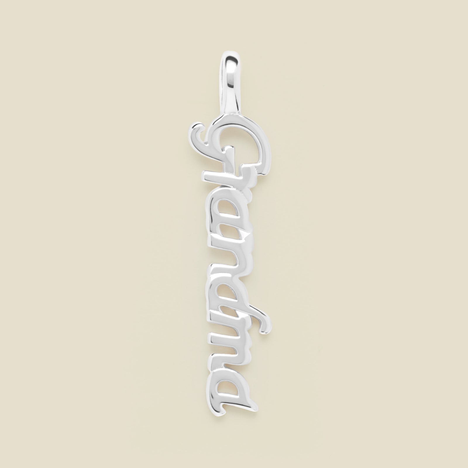 Silver "Grandma" charm on a beige background